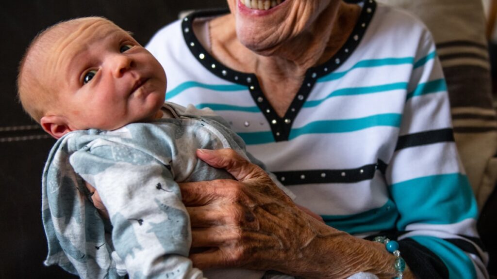 Setting boundaries with grandparents - a grandparent holding a grandchild