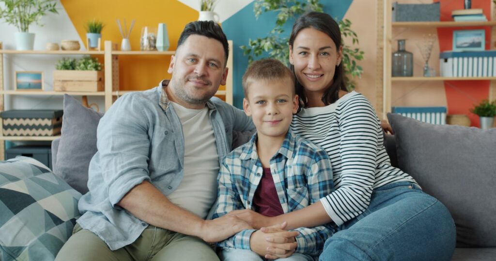 Parents and child on a couch, illustrating parenting as a team