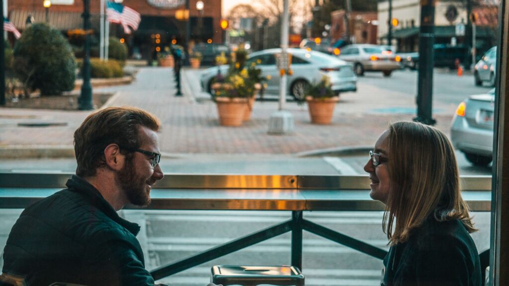 A married couple sitting and talking calmly, illustrating privacy vs secrecy in marriage