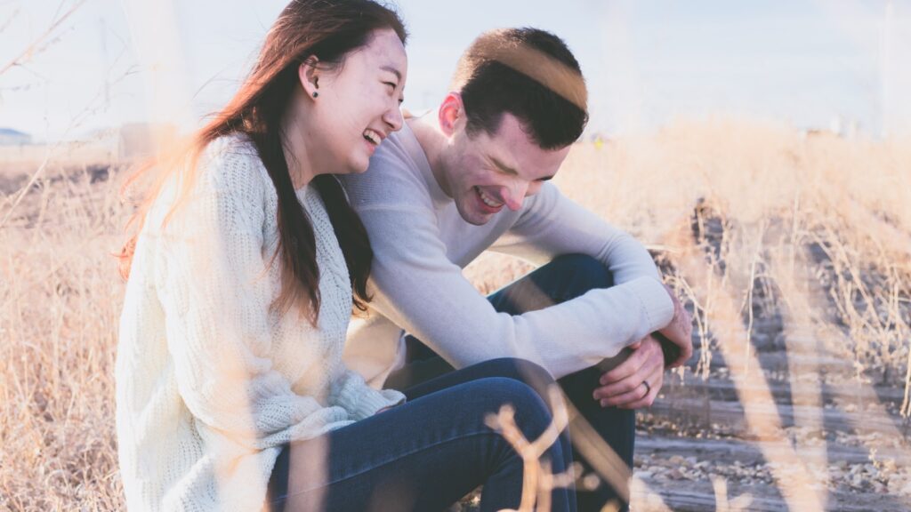A couple laughing together, re-meeting each other