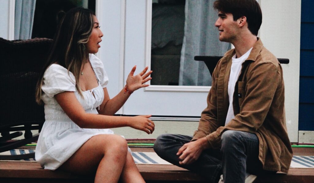 An engaged couple talking through wedding planning stress on relationships