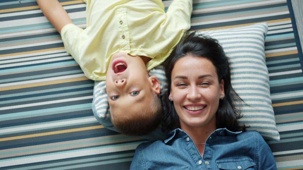 A default parent playing with their child on the floor at home