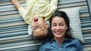 A default parent playing with their child on the floor at home