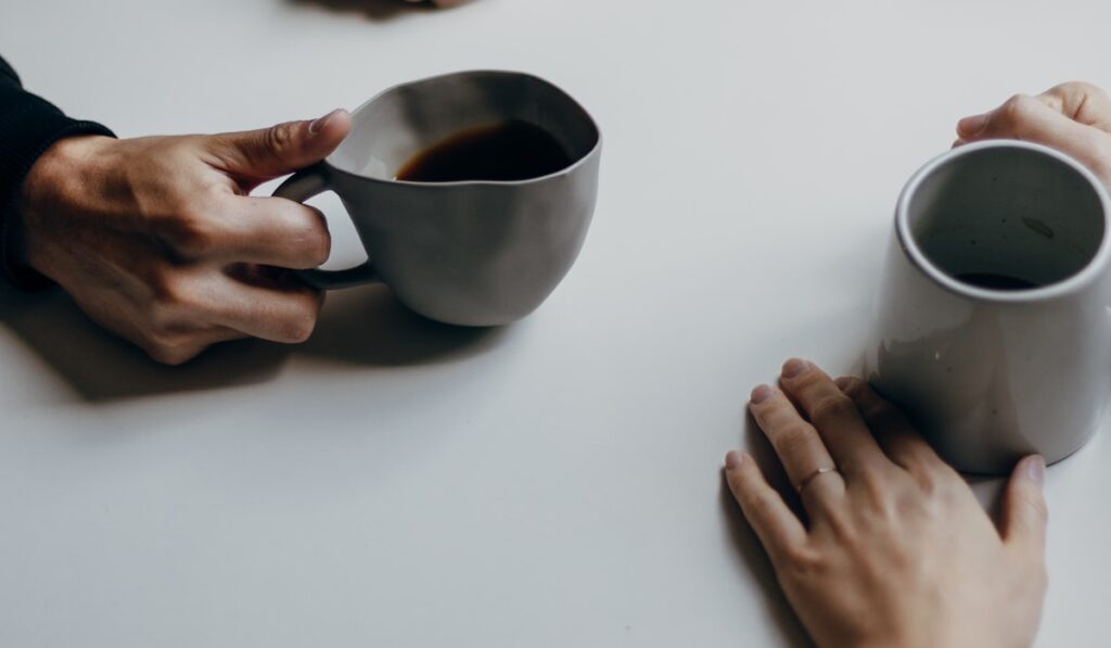 A couple sharing coffee during their magic five hours weekly ritual