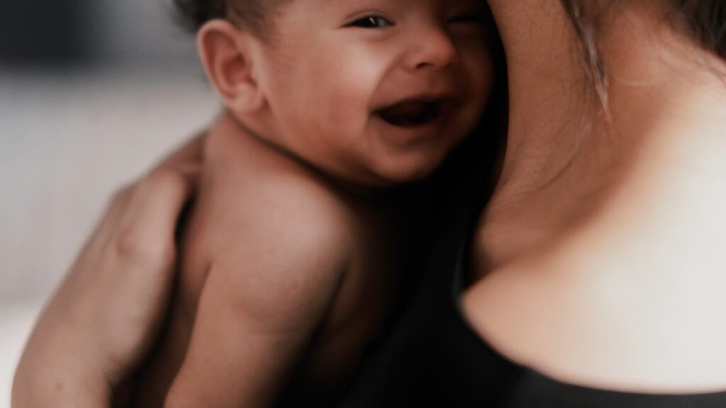 A parent and baby face to face, illustrating rupture and repair in attachment