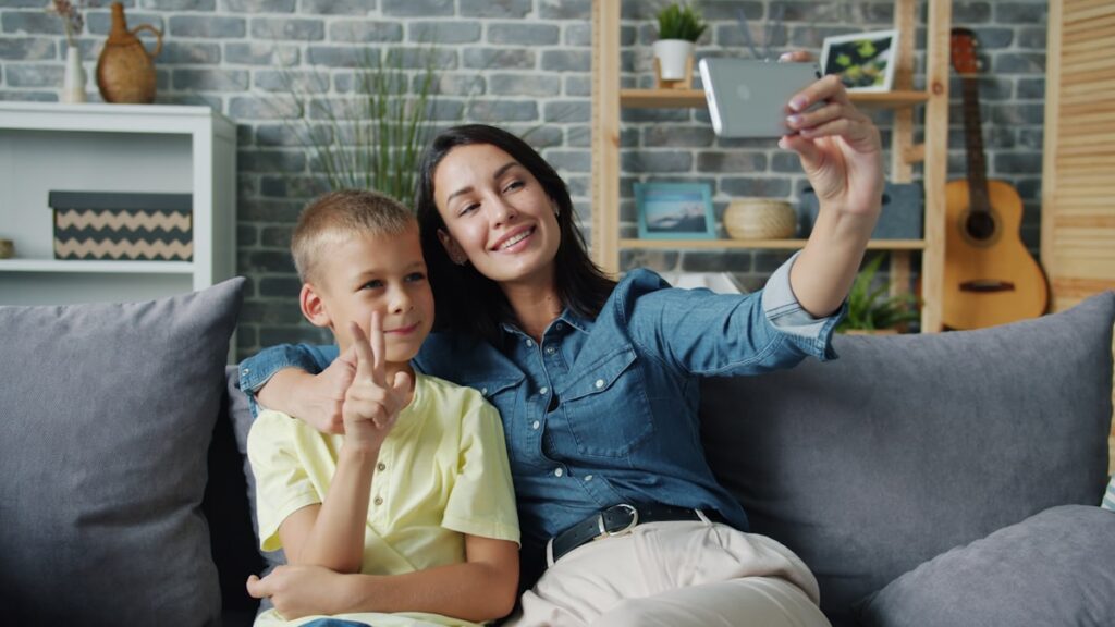 Parent and child taking a selfie, illustrating sharenting