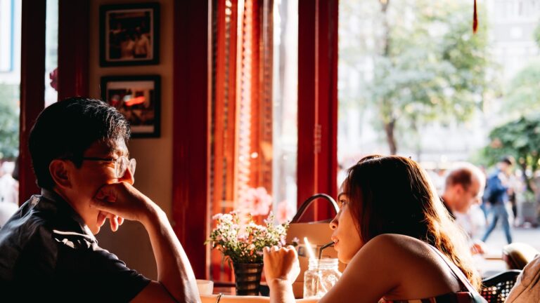 Man sitting at a cafe table waiting for a date