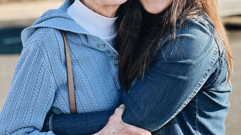 Two women embracing, the quiet grief of adult children of divorce
