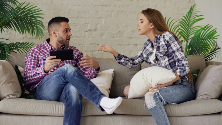 Couple sitting apart on a sofa during an on-again off-again relationship