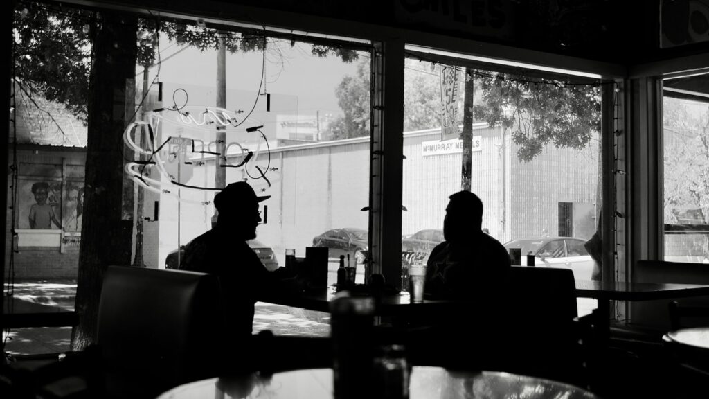 Man and woman talking across a table on a first date