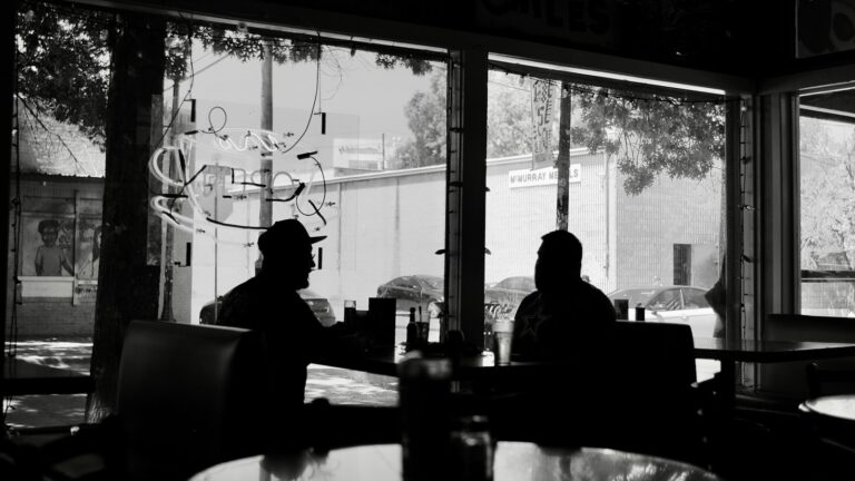 Man and woman talking across a table on a first date