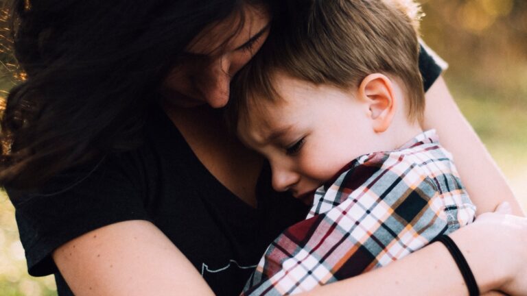 Mother holding her son, supporting a child through divorce