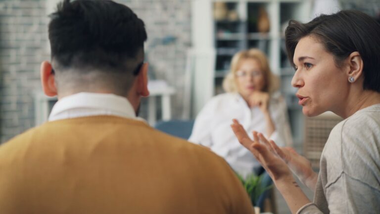 Mother talking with her adult child across a table