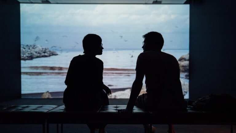 A couple sitting in silhouette when one spouse wants a divorce and the other doesn't
