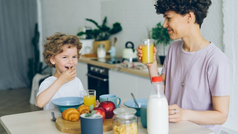 A parent and child talking at a kitchen table, illustrating parentification in families