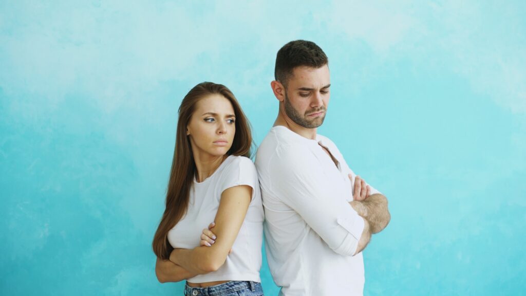 Married couple standing apart, illustrating resentment in marriage