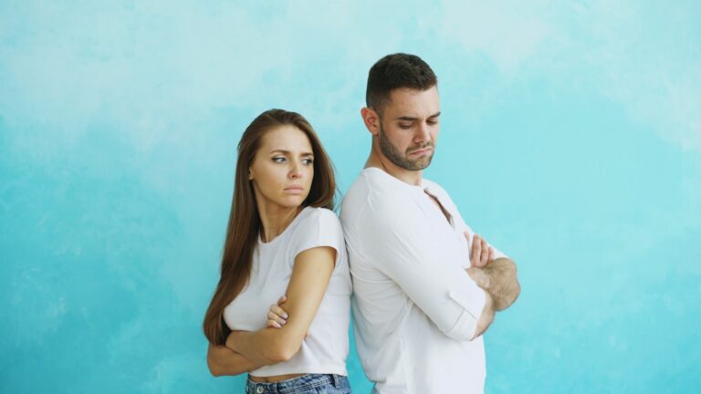 Married couple standing apart, illustrating resentment in marriage