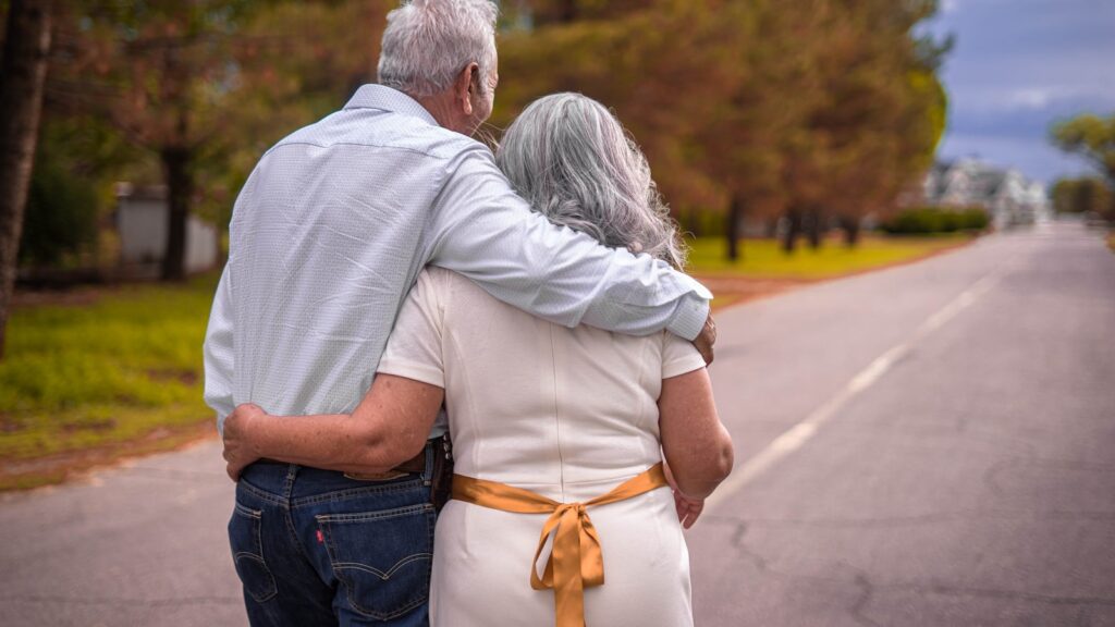 Older couple walking together outdoors