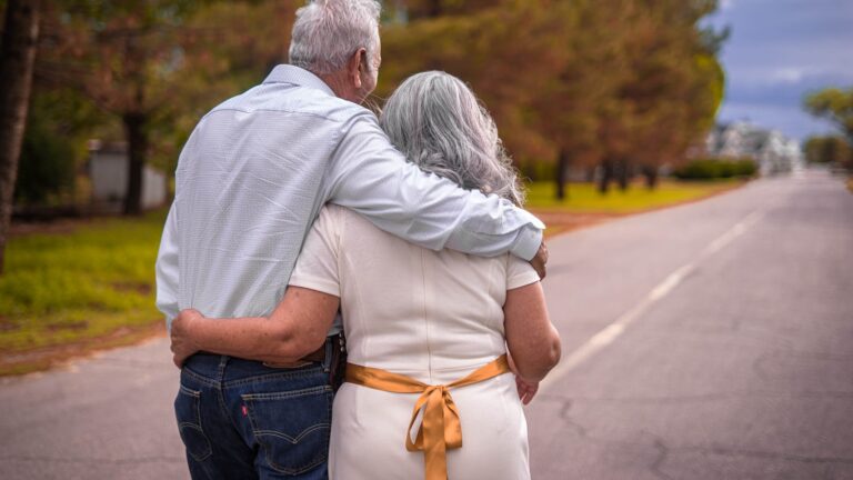 Older couple walking together outdoors