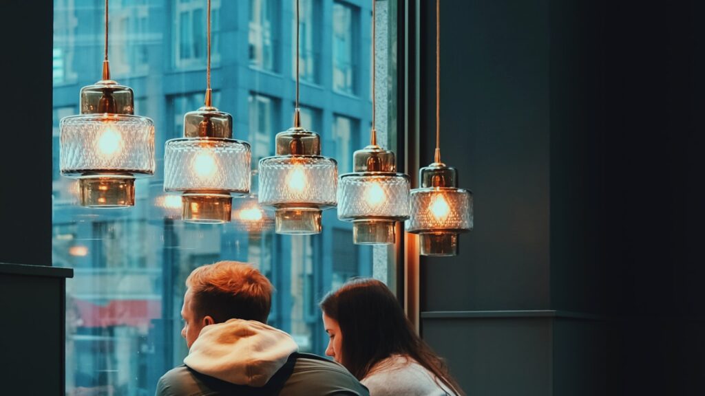 Two people talking at a window table on a date