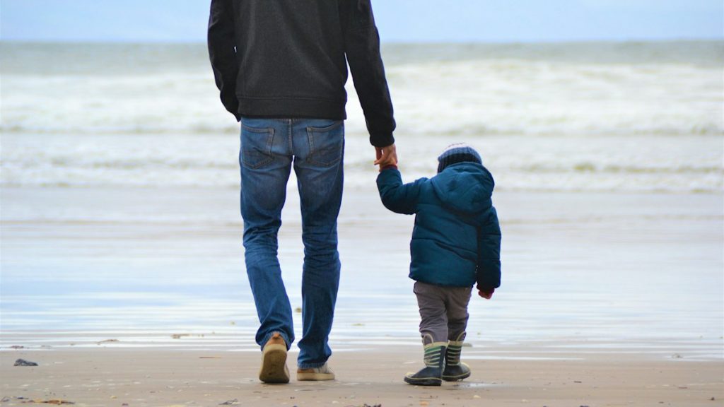 A parent and child walking together, showing autonomy-supportive parenting