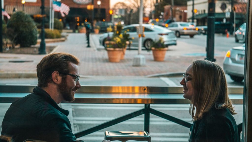A couple calmly working through a complaint vs criticism moment at the kitchen table