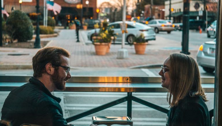 A couple calmly working through a complaint vs criticism moment at the kitchen table