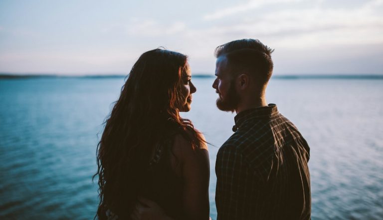 Couple standing close together outdoors, illustrating self-expansion theory relationships