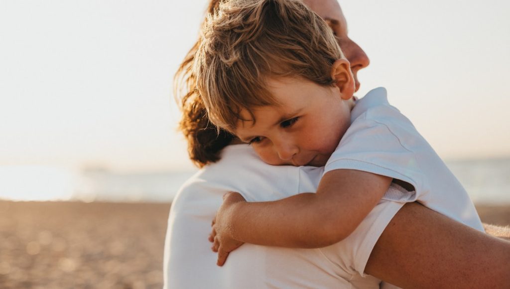A parent and child embracing, illustrating goodness of fit in parenting