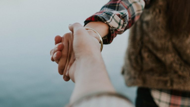 Couple silhouetted at sunset representing enmeshment in marriage