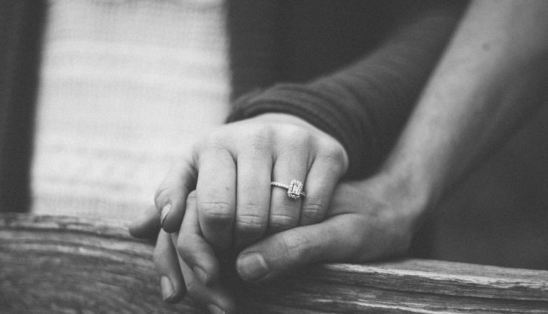 A couple holding hands before getting engaged