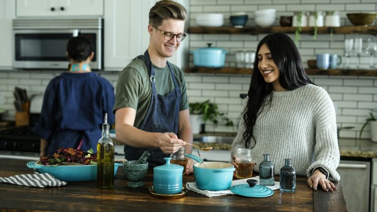 Smiling couple cooking together, sharing traditions in intercultural relationships