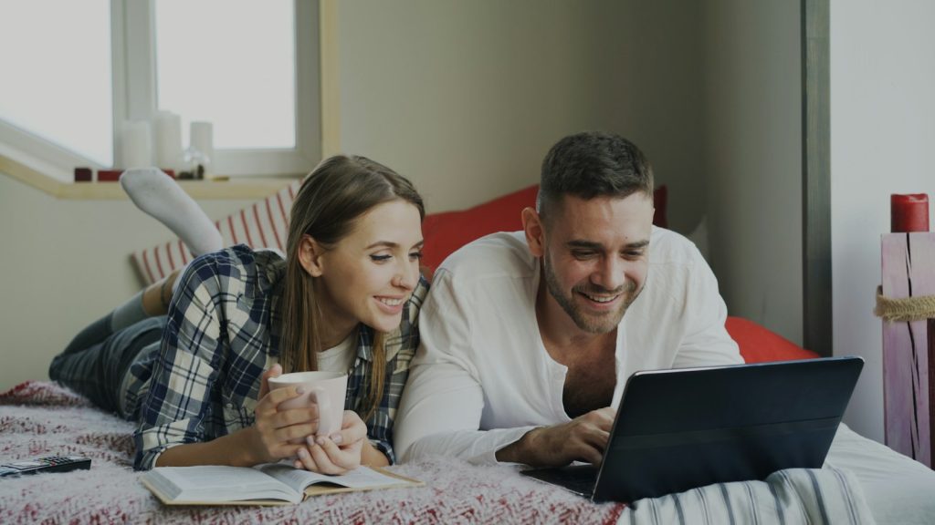 Couple looking at a laptop together while working from home with your spouse