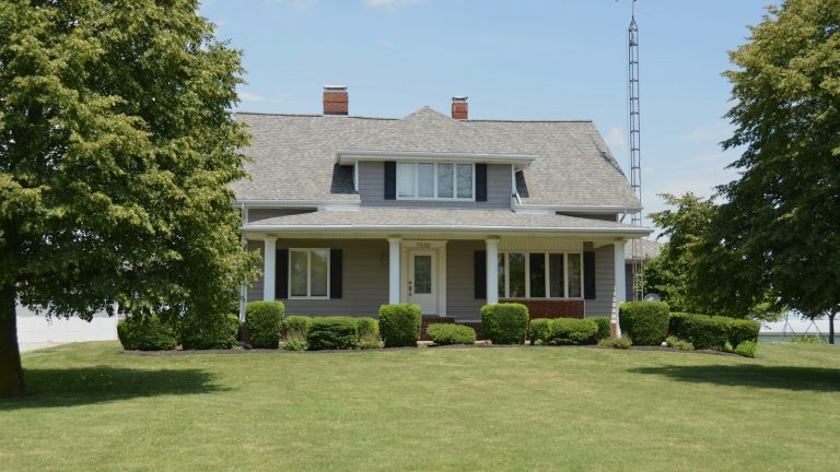 Grey family house with a front porch, the focus of keeping the house in divorce decisions