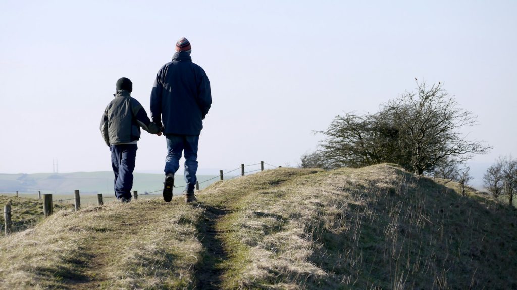 Father and son walking together after a child refuses visitation