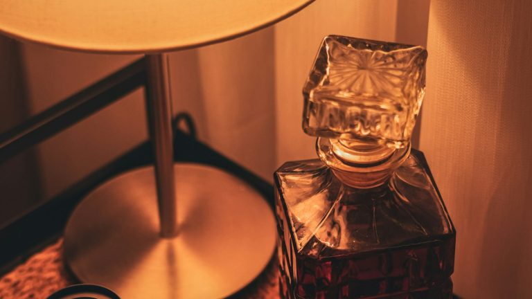 Glass of whiskey beside a decanter, a scene familiar when a spouse drinks too much