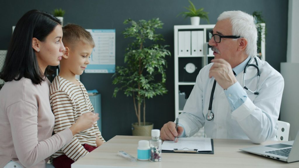 Professional meeting with a mother and child at a desk during a custody evaluation
