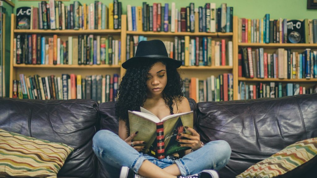 Woman reading alone on a couch, enjoying alone time in marriage